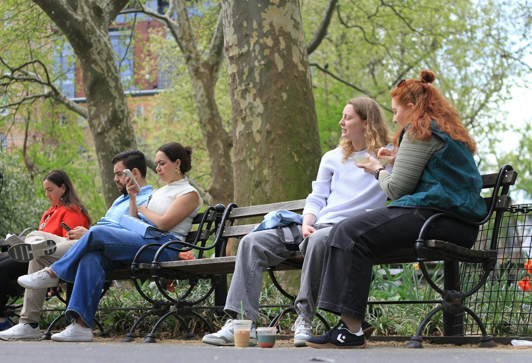 people chatting on public bench