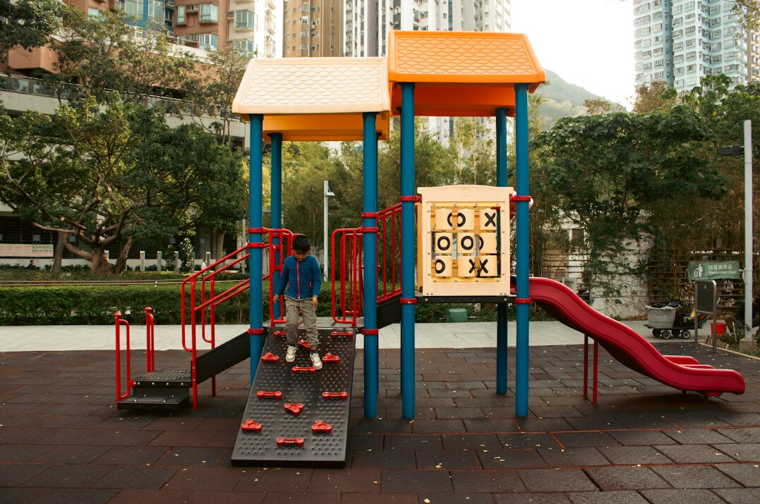 Children and families playing in a public park playground