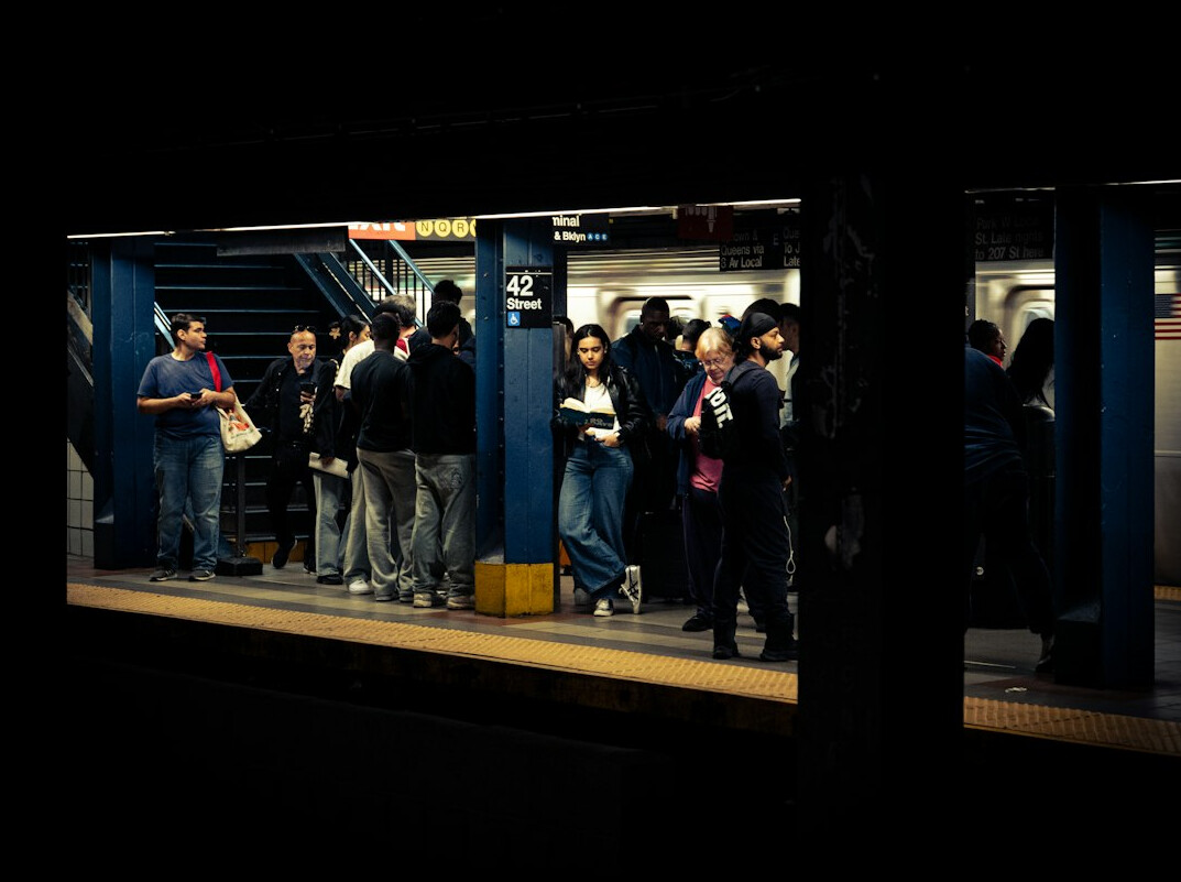Commuters waiting on a public transit platform in the morning