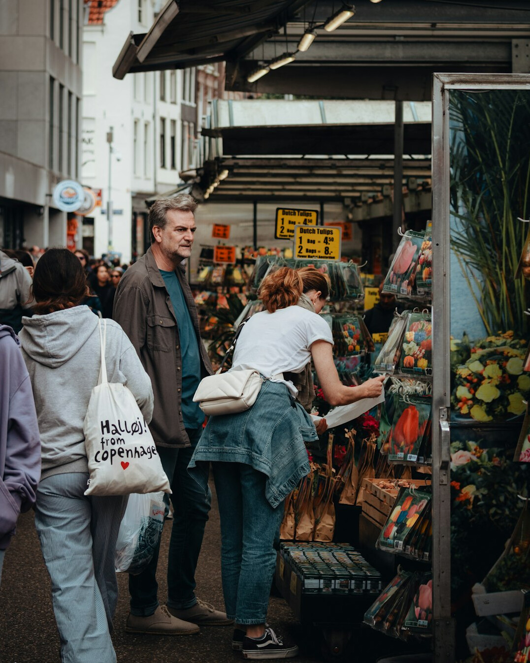Shoppers browsing stalls at an outdoor public market