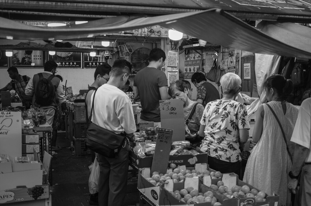 busy outdoor market with people browsing stalls