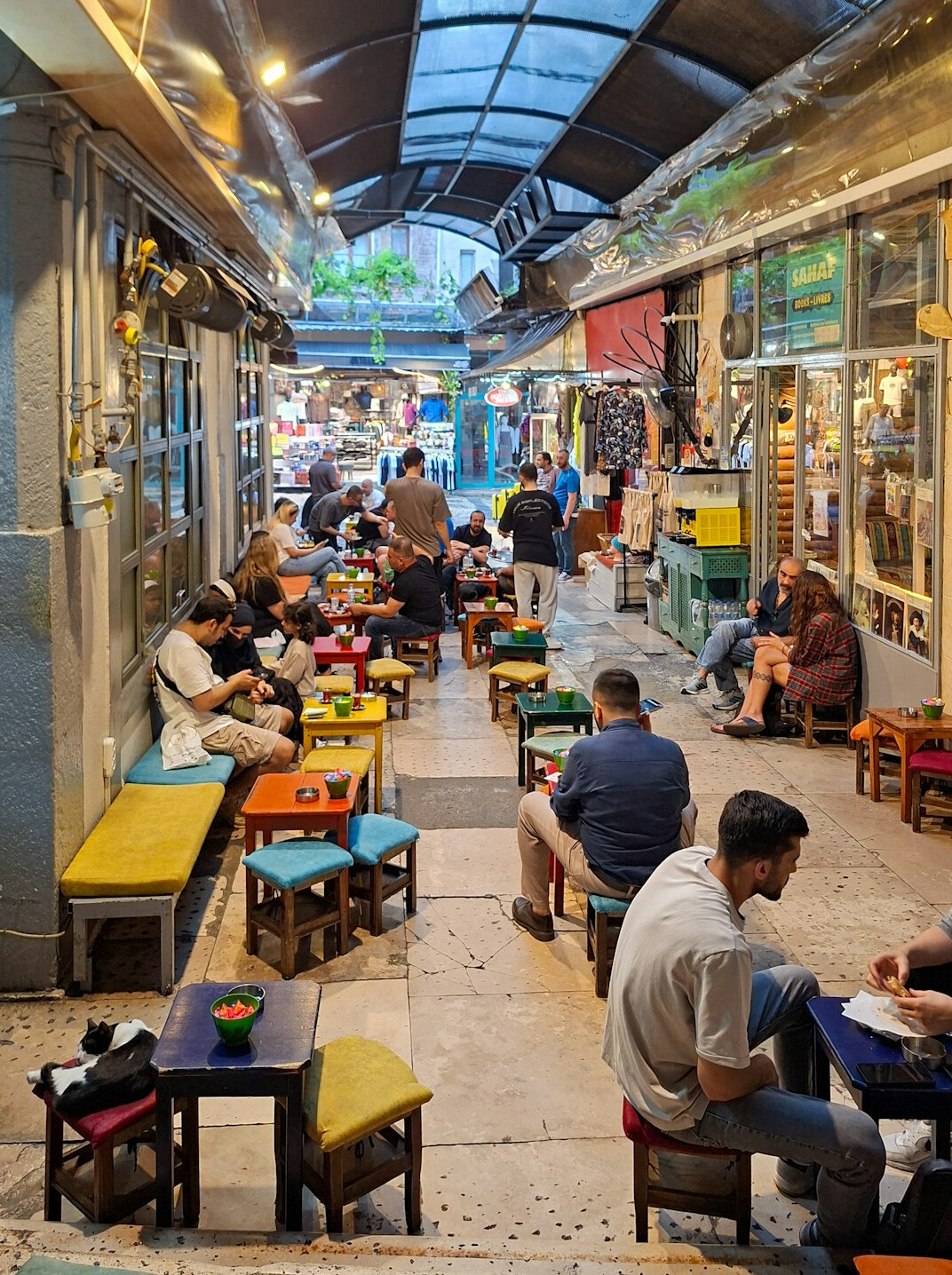 people sitting and eating at market tables