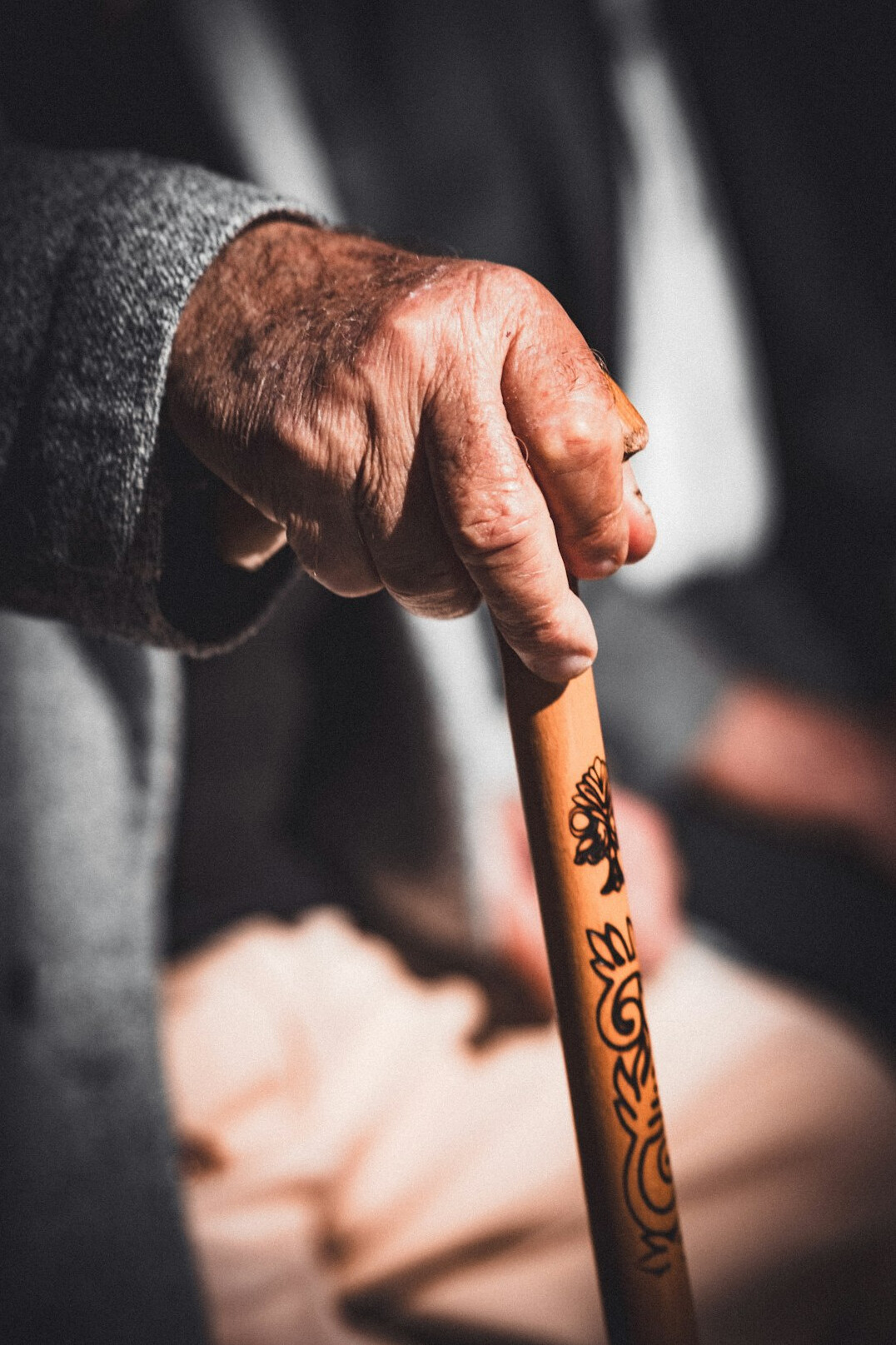 elderly person walking with cane