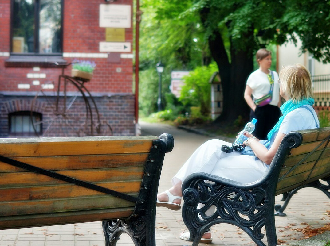 two strangers talking on bench