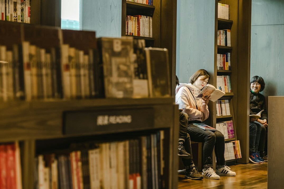 Visitors reading inside a public library reading room